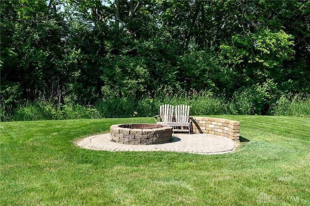 243 Woodside Trl, Clearcreek Twp, OH 45036 - view of grassy yard with an outdoor fire pit and a patio area