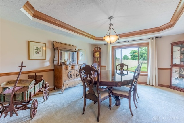 3875 Ferry Rd, Sugarcreek Twp, OH 45305 - dining space featuring a raised ceiling, light colored carpet, ornamental molding, and a textured ceiling