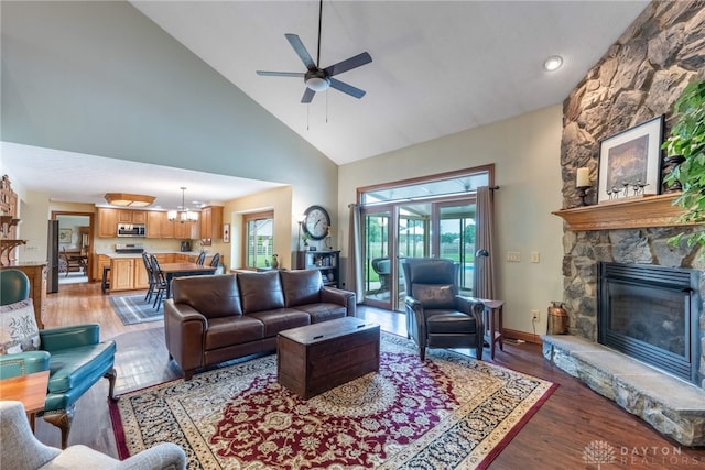 3875 Ferry Rd, Sugarcreek Twp, OH 45305 - living room with high vaulted ceiling, ceiling fan, light wood finished floors, and a stone fireplace
