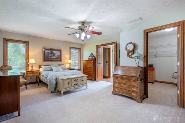 3875 Ferry Rd, Sugarcreek Twp, OH 45305 - bedroom featuring light carpet, a spacious closet, a closet, ceiling fan, and a textured ceiling
