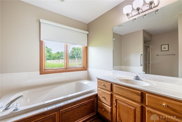 3875 Ferry Rd, Sugarcreek Twp, OH 45305 - bathroom with vanity, a garden tub, and a shower with door