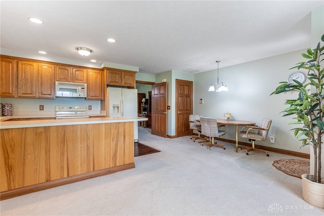 3875 Ferry Rd, Sugarcreek Twp, OH 45305 - kitchen featuring white appliances, light countertops, recessed lighting, light carpet, and hanging light fixtures