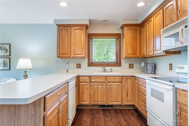 3875 Ferry Rd, Sugarcreek Twp, OH 45305 - kitchen with white appliances, a peninsula, light countertops, recessed lighting, and dark wood-style floors