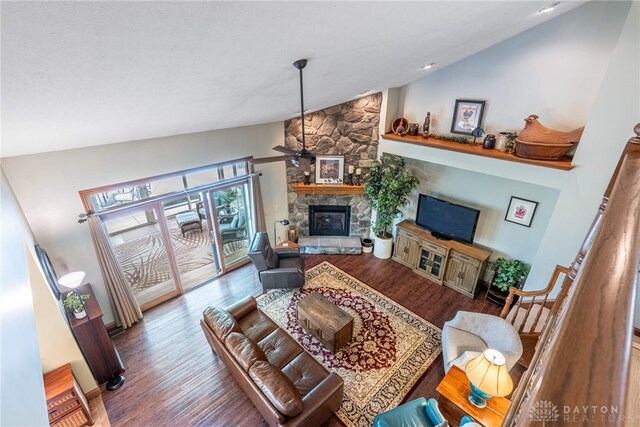 3875 Ferry Rd, Sugarcreek Twp, OH 45305 - living room featuring vaulted ceiling, a stone fireplace, and wood finished floors