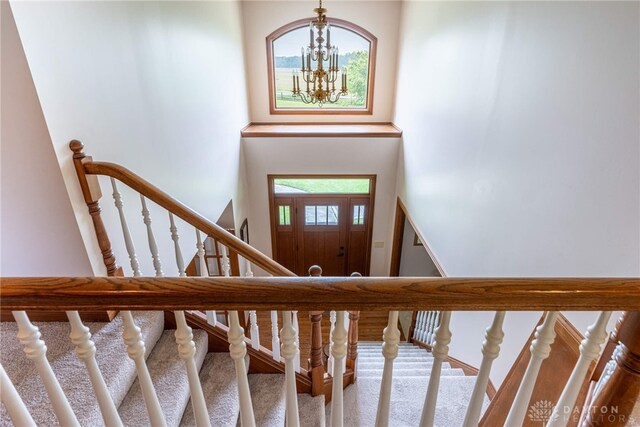 3875 Ferry Rd, Sugarcreek Twp, OH 45305 - foyer with a towering ceiling, a chandelier, and stairway