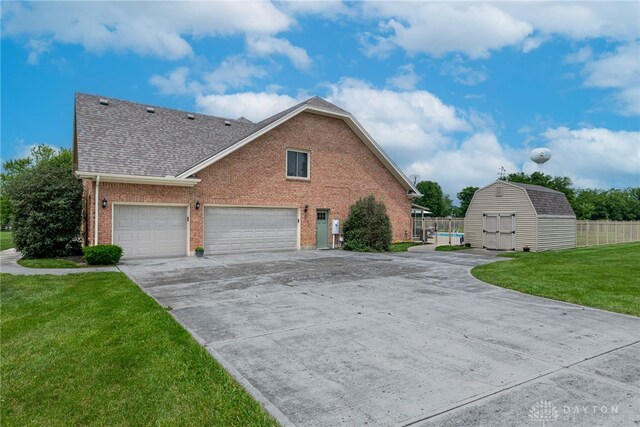 3875 Ferry Rd, Sugarcreek Twp, OH 45305 - view of side of property with brick siding, a shed, roof with shingles, and driveway