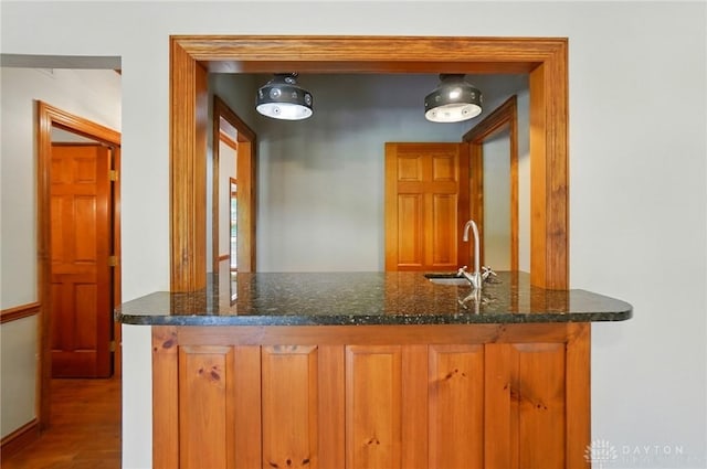 7255 State Route 48, Springboro, OH 45066 - kitchen featuring wood finished floors, brown cabinets, and dark stone countertops