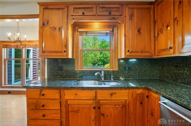 7255 State Route 48, Springboro, OH 45066 - kitchen featuring dishwasher, brown cabinets, a chandelier, decorative backsplash, and dark stone counters