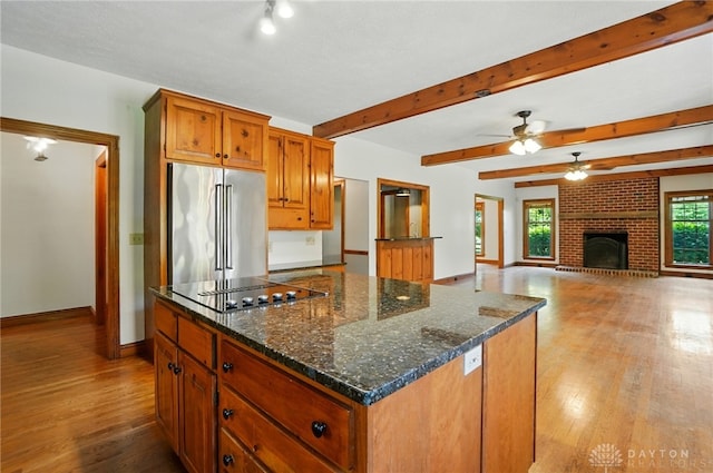 7255 State Route 48, Springboro, OH 45066 - kitchen with high quality fridge, black electric stovetop, wood finished floors, ceiling fan, and brown cabinetry