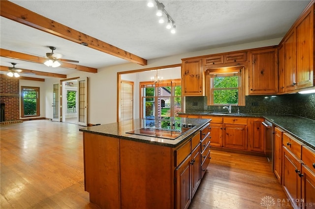 7255 State Route 48, Springboro, OH 45066 - kitchen featuring black electric cooktop, open floor plan, light wood-style flooring, decorative backsplash, and beamed ceiling