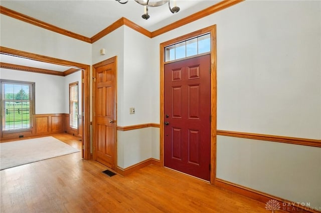 7255 State Route 48, Springboro, OH 45066 - entryway with ornamental molding, light wood-style flooring, a chandelier, and a wainscoted wall