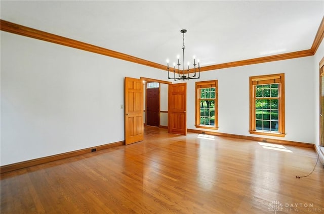 7255 State Route 48, Springboro, OH 45066 - empty room with a chandelier, ornamental molding, and light wood-style flooring