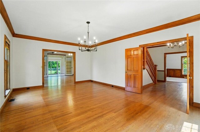 7255 State Route 48, Springboro, OH 45066 - spare room with a chandelier, light wood-type flooring, ornamental molding, and stairway