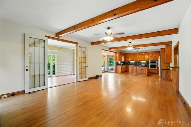 7255 State Route 48, Springboro, OH 45066 - unfurnished living room with plenty of natural light, light wood-type flooring, ceiling fan, and beam ceiling