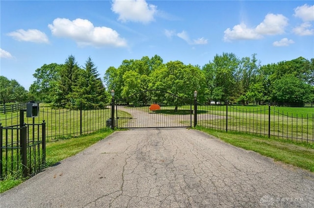 7255 State Route 48, Springboro, OH 45066 - view of asphalt driveway with a gate, a gated entry, and view of wooded area