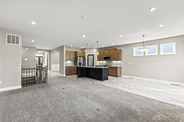1796 Archerfield Pl, Miamisburg, OH 45342 - kitchen featuring open floor plan, appliances with stainless steel finishes, recessed lighting, a center island with sink, and decorative light fixtures