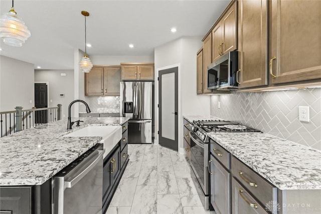 1796 Archerfield Pl, Miamisburg, OH 45342 - kitchen featuring appliances with stainless steel finishes, light marble finish floors, recessed lighting, light stone countertops, and decorative backsplash