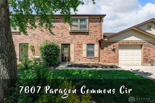 7607 Paragon Commons Cir, Dayton, OH 45459 - view of front of property with concrete driveway, brick siding, a garage, and a front yard