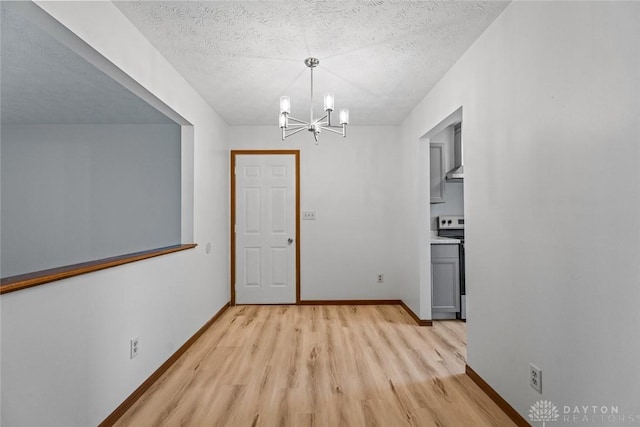 7607 Paragon Commons Cir, Dayton, OH 45459 - unfurnished dining area with light wood-style floors, a chandelier, and a textured ceiling