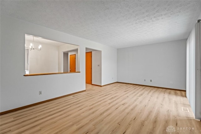 7607 Paragon Commons Cir, Dayton, OH 45459 - unfurnished room with wood finished floors, a chandelier, and a textured ceiling