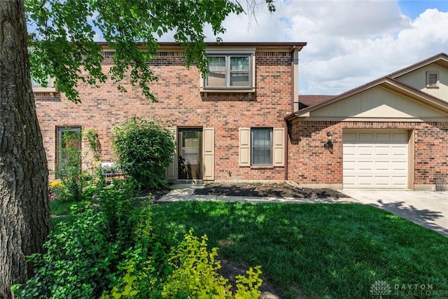 7607 Paragon Commons Cir, Dayton, OH 45459 - view of front of home with driveway, brick siding, an attached garage, and a front lawn