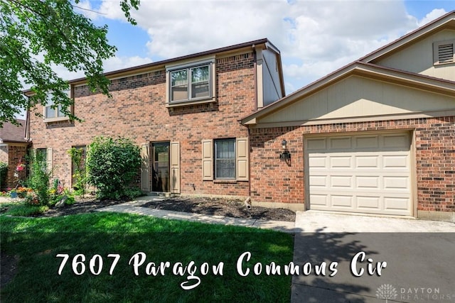 7607 Paragon Commons Cir, Dayton, OH 45459 - view of front of home with brick siding, a garage, and concrete driveway