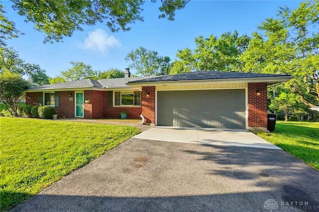 320 Witherby Dr, Kettering, OH 45429 - view of front of house with an attached garage, concrete driveway, a front yard, a chimney, and brick siding