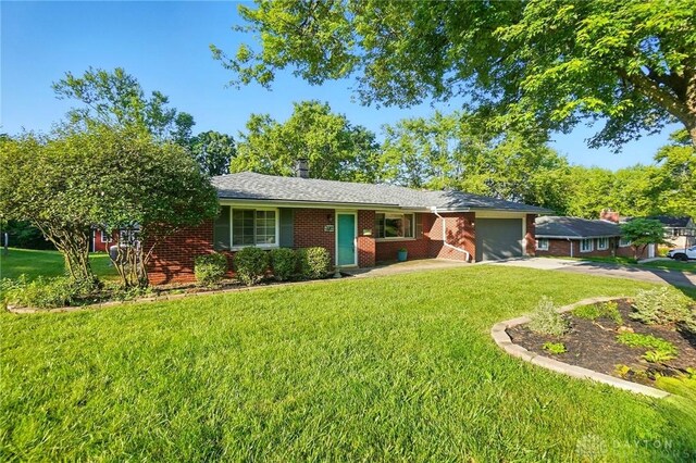 320 Witherby Dr, Kettering, OH 45429 - ranch-style home featuring an attached garage, concrete driveway, a front yard, and brick siding