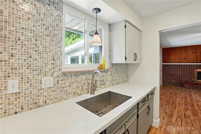 320 Witherby Dr, Kettering, OH 45429 - kitchen with decorative backsplash, pendant lighting, light countertops, light wood-style flooring, and white cabinets