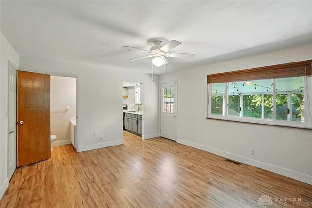 320 Witherby Dr, Kettering, OH 45429 - unfurnished living room with a ceiling fan and light wood-style floors