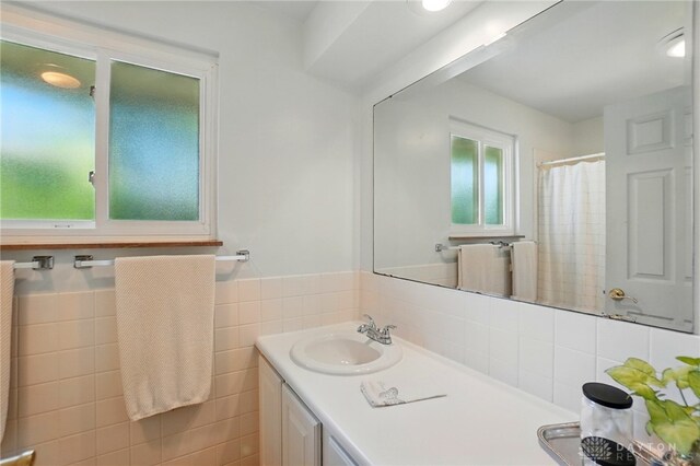 320 Witherby Dr, Kettering, OH 45429 - bathroom with vanity, tile walls, wainscoting, and a shower with shower curtain