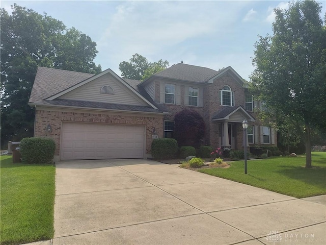 1052 Windpointe Way, Englewood, OH 45322 - view of front facade with concrete driveway, a front lawn, brick siding, roof with shingles, and an attached garage