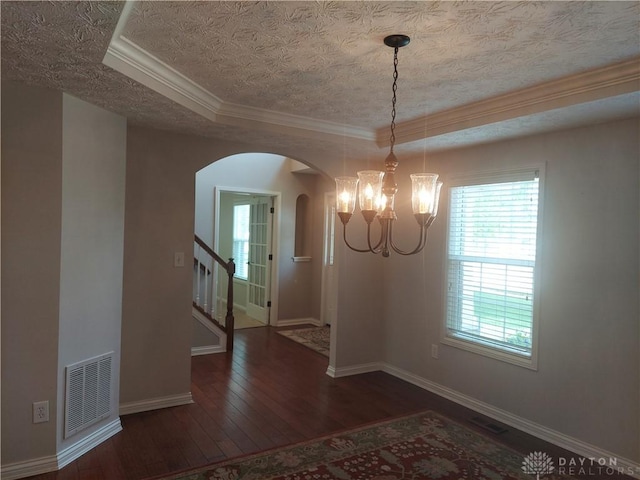 1052 Windpointe Way, Englewood, OH 45322 - unfurnished dining area featuring arched walkways, hardwood / wood-style floors, a chandelier, stairway, and crown molding