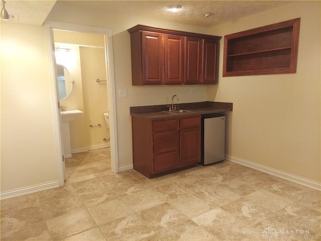 1052 Windpointe Way, Englewood, OH 45322 - kitchen with dark countertops, dishwashing machine, open shelves, and a textured ceiling