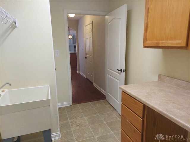1052 Windpointe Way, Englewood, OH 45322 - laundry room featuring baseboards and a sink