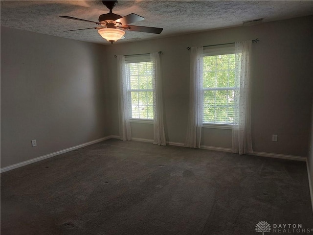 1052 Windpointe Way, Englewood, OH 45322 - empty room featuring plenty of natural light, a textured ceiling, ceiling fan, and carpet floors