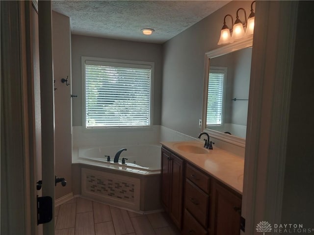 1052 Windpointe Way, Englewood, OH 45322 - bathroom featuring a bath, vanity, a textured ceiling, and tile patterned flooring