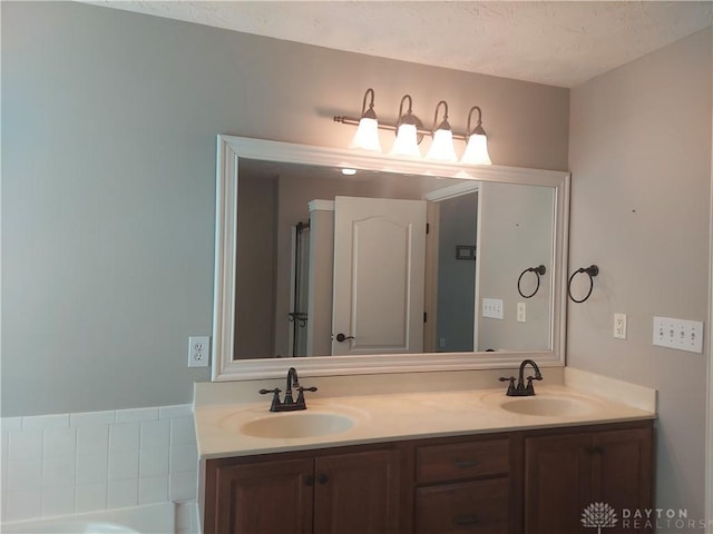 1052 Windpointe Way, Englewood, OH 45322 - full bathroom with double vanity, a textured ceiling, and a bath