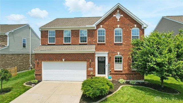 1662 S Branch Rd, Centerville, OH 45458 - view of front of home featuring brick siding, a front yard, an attached garage, concrete driveway, and roof with shingles