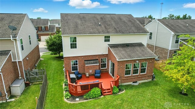 1662 S Branch Rd, Centerville, OH 45458 - rear view of property featuring brick siding, a wooden deck, roof with shingles, and a fenced backyard