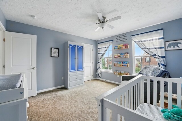 1662 S Branch Rd, Centerville, OH 45458 - carpeted bedroom with a crib, a textured ceiling, and ceiling fan