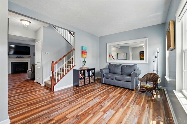 1662 S Branch Rd, Centerville, OH 45458 - living area featuring stairs, wood finished floors, and a fireplace