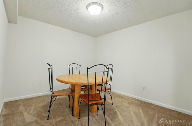 1662 S Branch Rd, Centerville, OH 45458 - carpeted dining space with baseboards and a textured ceiling