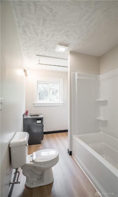 675 W Geiserman Rd, Piqua, OH 45356 - bathroom featuring wood finished floors, a textured ceiling, and tub / shower combination