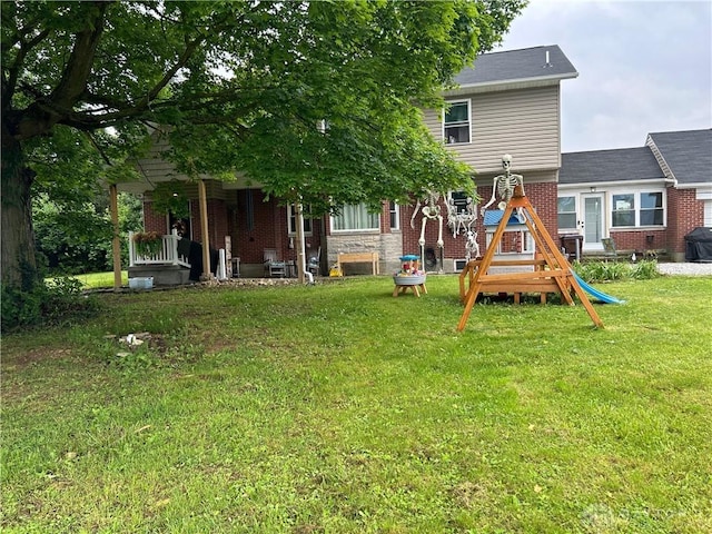 3348 Phillipsburg Union Rd, Englewood, OH 45322 - back of house featuring a yard, brick siding, and a playground