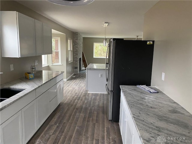 3348 Phillipsburg Union Rd, Englewood, OH 45322 - kitchen with freestanding refrigerator, dark wood finished floors, light stone counters, and white cabinetry