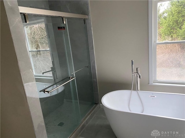 3348 Phillipsburg Union Rd, Englewood, OH 45322 - full bathroom with healthy amount of natural light, a freestanding bath, and a stall shower
