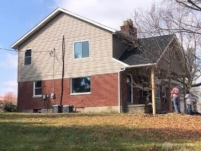 3348 Phillipsburg Union Rd, Englewood, OH 45322 - view of home's exterior featuring a chimney, brick siding, and a yard