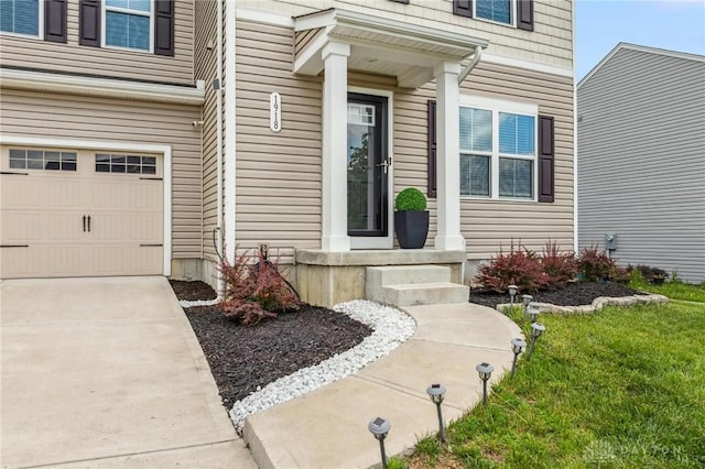 1918 Bessie Ave, Moraine, OH 45439 - view of exterior entry with a garage and concrete driveway