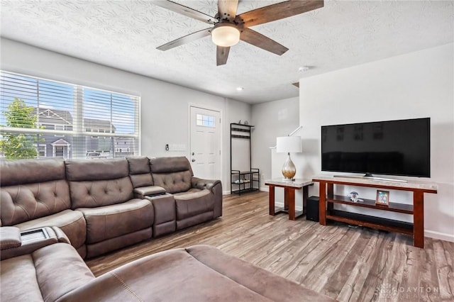 1918 Bessie Ave, Moraine, OH 45439 - living area with a textured ceiling, wood finished floors, and a ceiling fan